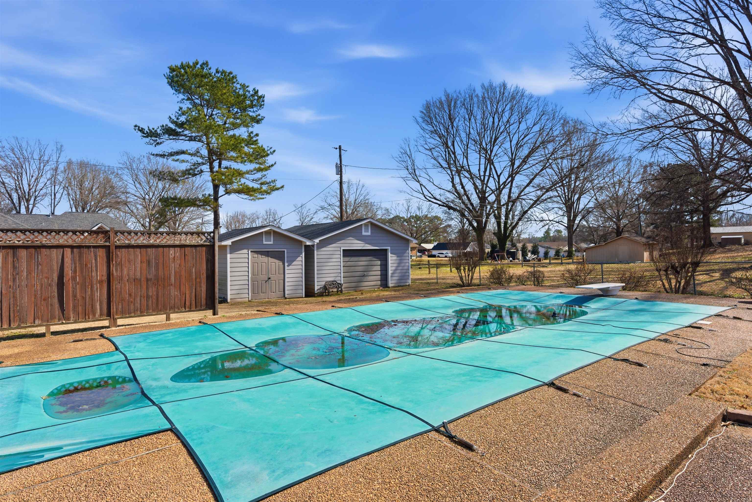 222 Barrett Street Bolivar, TN 38008 - Photo 28 of 30 View of swimming pool with patio surround, a diving board, and a storage shed