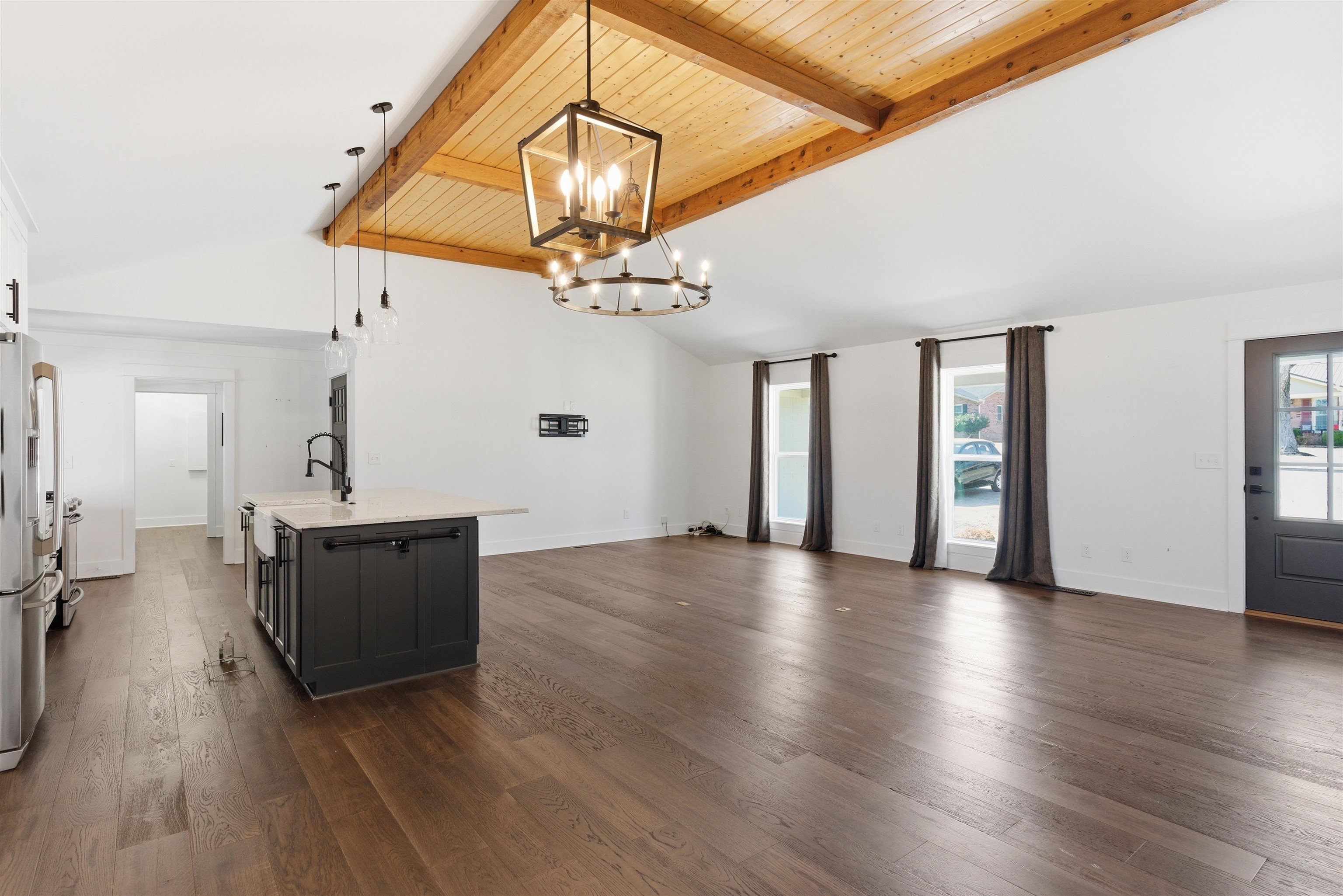 222 Barrett Street Bolivar, TN 38008 - Photo 6 of 30 Unfurnished living room with dark wood-style flooring, healthy amount of natural light, a high wooden beamed ceiling, and hanging lights