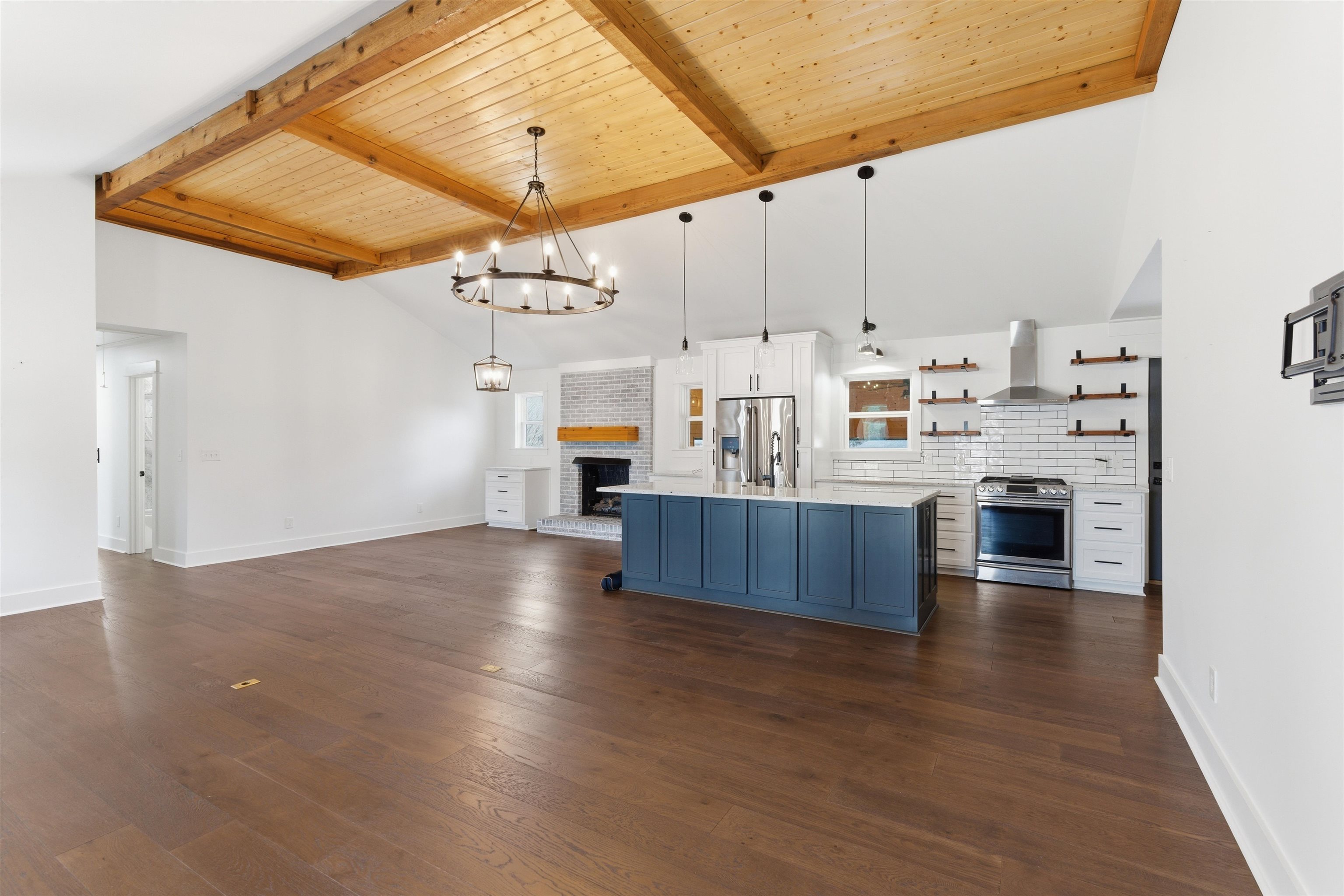 222 Barrett Street Bolivar, TN 38008 - Photo 30 of 30 Kitchen with open shelves, a chandelier, two tone cabinetry, open floor plan, and stainless steel appliances