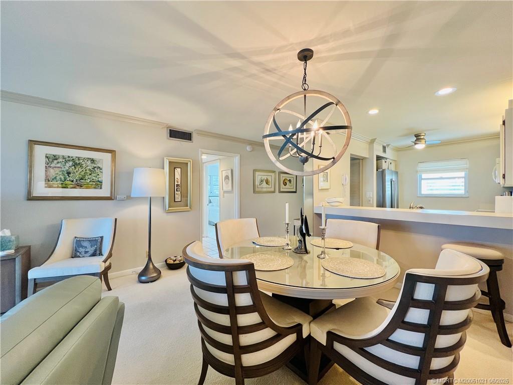 1550 Northeast Ocean Boulevard, Unit C204 Stuart, FL 34996 - Photo 11 of 54 a view of a dining room with furniture and wooden floor