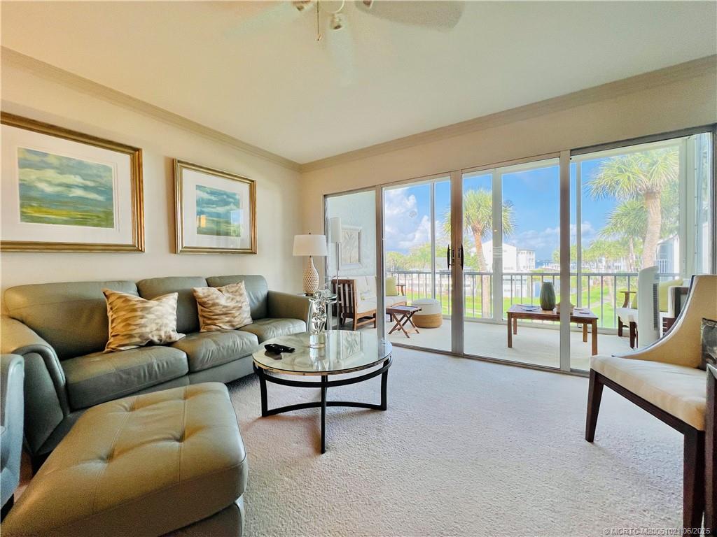 1550 Northeast Ocean Boulevard, Unit C204 Stuart, FL 34996 - Photo 15 of 54 a living room with furniture and a large window with balcony view