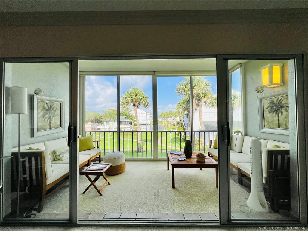 1550 Northeast Ocean Boulevard, Unit C204 Stuart, FL 34996 - Photo 18 of 54 a living room with furniture and a floor to ceiling window