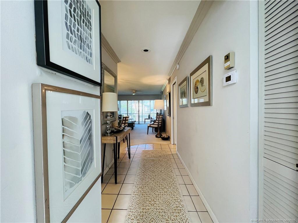1550 Northeast Ocean Boulevard, Unit C204 Stuart, FL 34996 - Photo 2 of 54 a hallway with furniture and a entryway