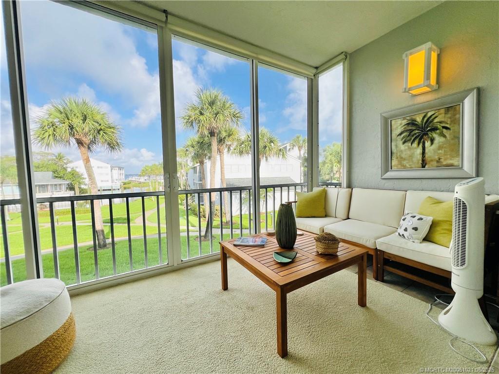1550 Northeast Ocean Boulevard, Unit C204 Stuart, FL 34996 - Photo 21 of 54 a living room with furniture and a floor to ceiling window