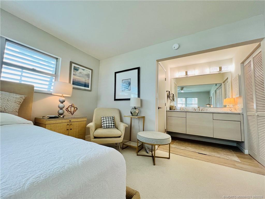1550 Northeast Ocean Boulevard, Unit C204 Stuart, FL 34996 - Photo 29 of 54 a bedroom with a bed and a couch