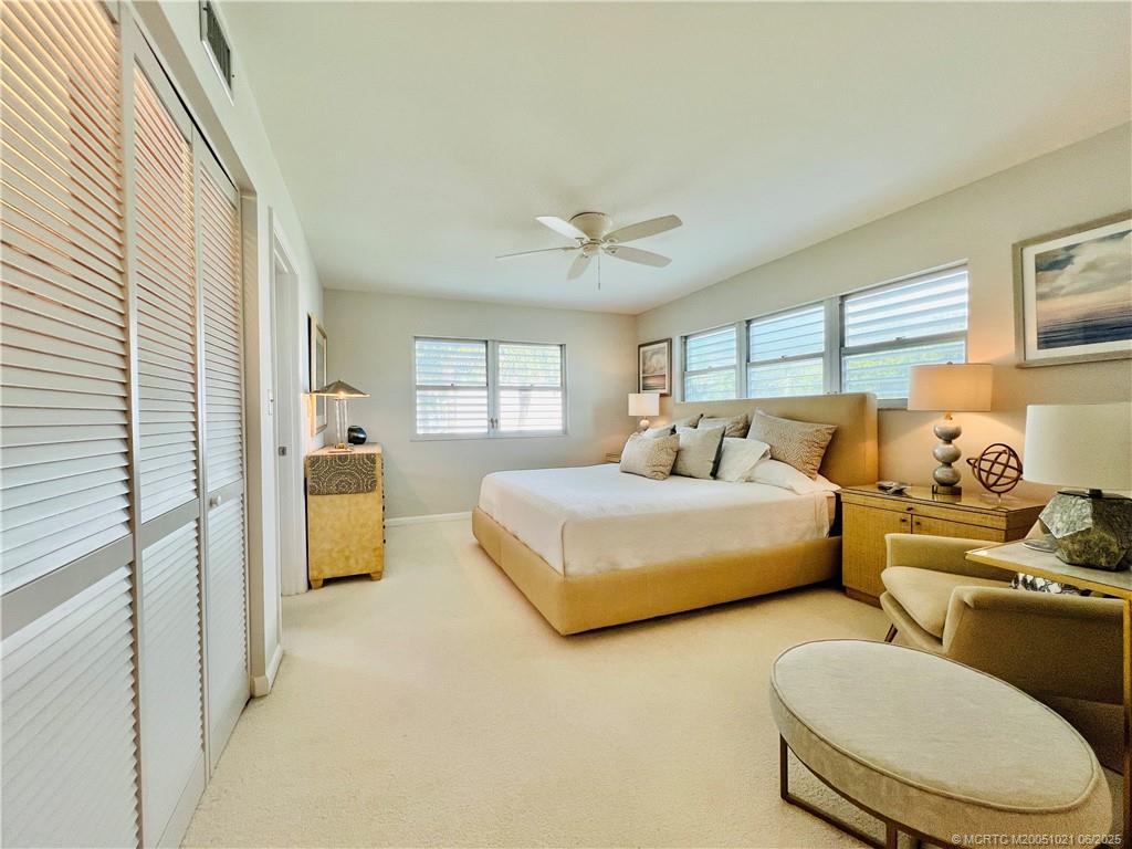 1550 Northeast Ocean Boulevard, Unit C204 Stuart, FL 34996 - Photo 31 of 54 a spacious bedroom with two beds and large window