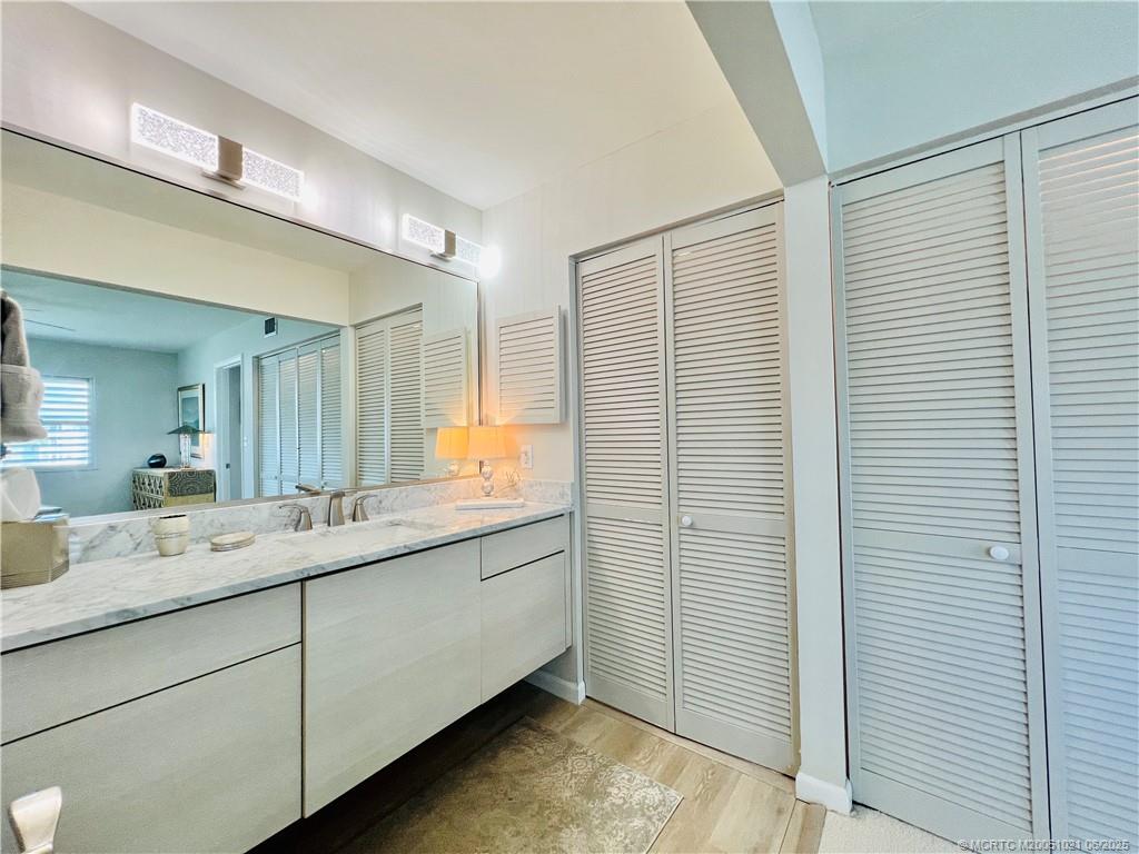 1550 Northeast Ocean Boulevard, Unit C204 Stuart, FL 34996 - Photo 32 of 54 a bathroom with a granite countertop sink and a mirror