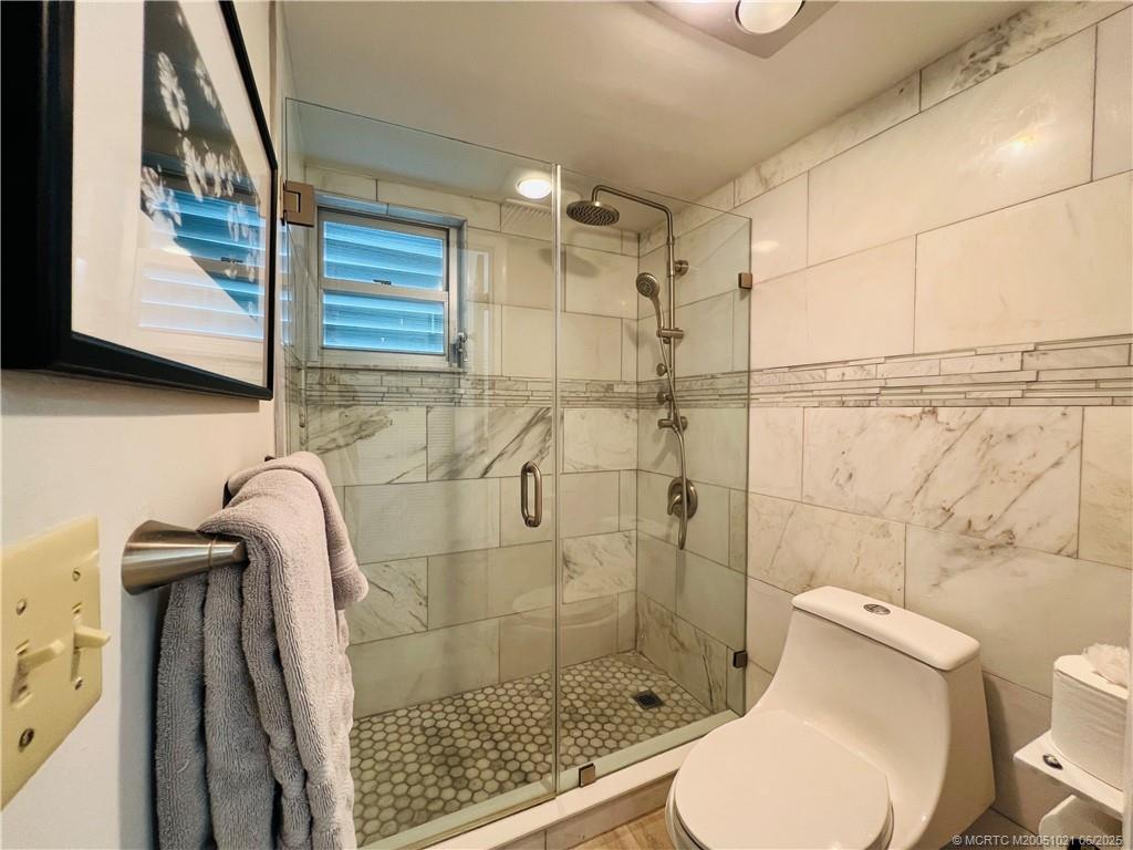 1550 Northeast Ocean Boulevard, Unit C204 Stuart, FL 34996 - Photo 34 of 54 a bathroom with a toilet and a shower