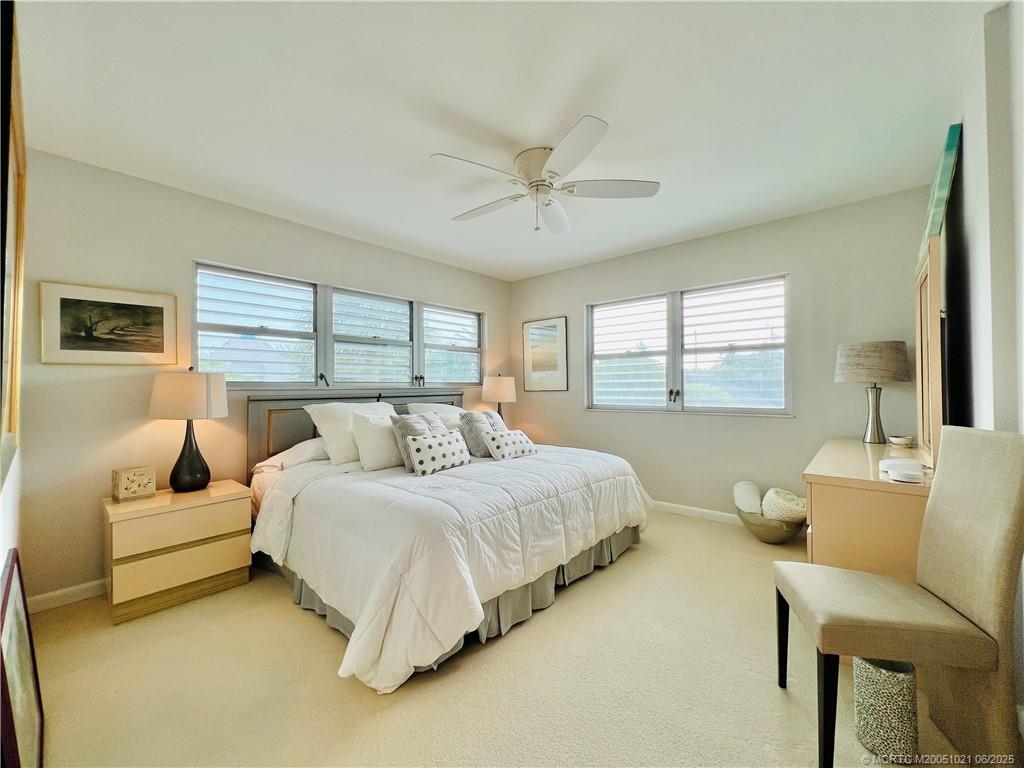 1550 Northeast Ocean Boulevard, Unit C204 Stuart, FL 34996 - Photo 39 of 54 a bedroom with a bed and a couch