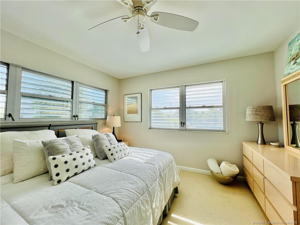 1550 Northeast Ocean Boulevard, Unit C204 Stuart, FL 34996 - Photo 40 of 54 a bedroom with bed and window