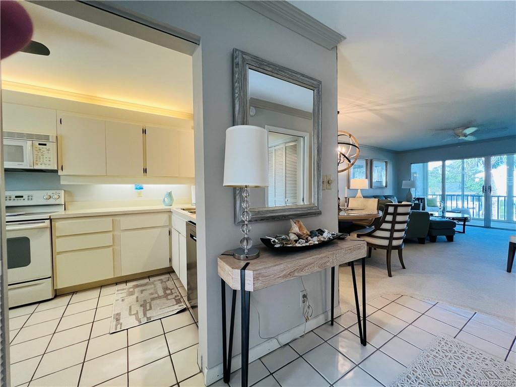 1550 Northeast Ocean Boulevard, Unit C204 Stuart, FL 34996 - Photo 4 of 54 a kitchen with a sink and cabinets