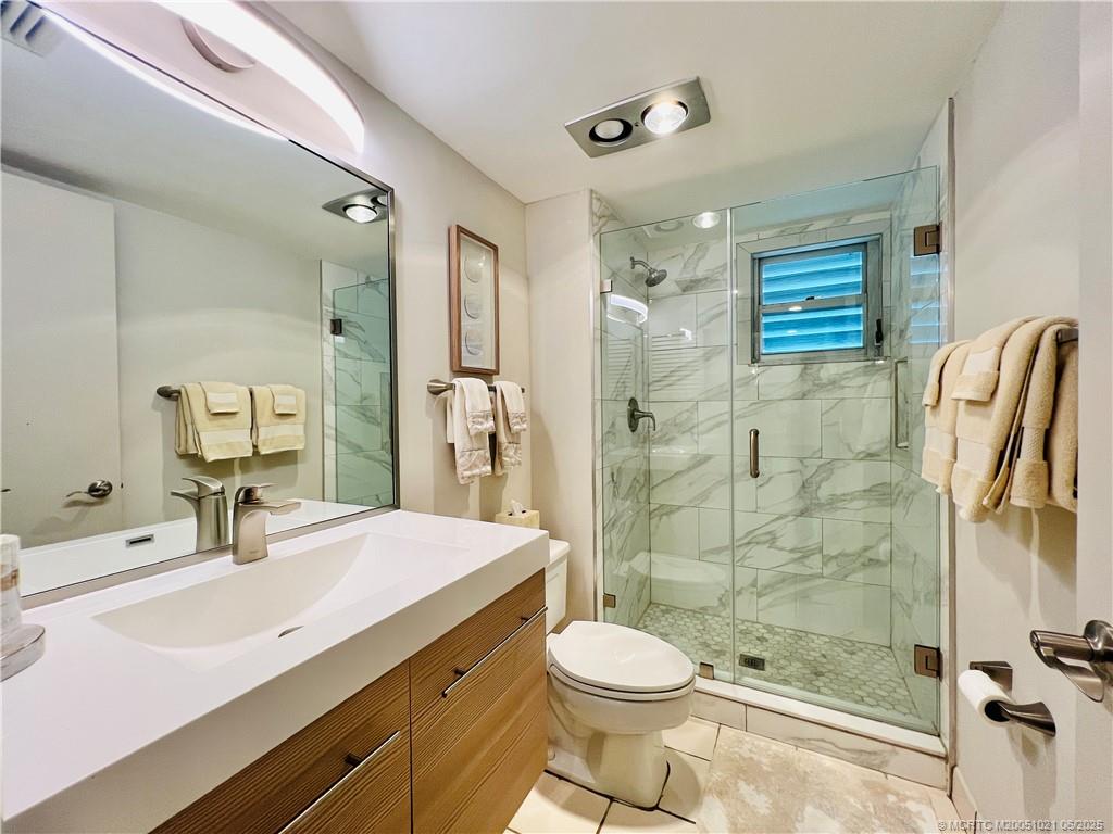 1550 Northeast Ocean Boulevard, Unit C204 Stuart, FL 34996 - Photo 44 of 54 a bathroom with a sink a toilet and shower