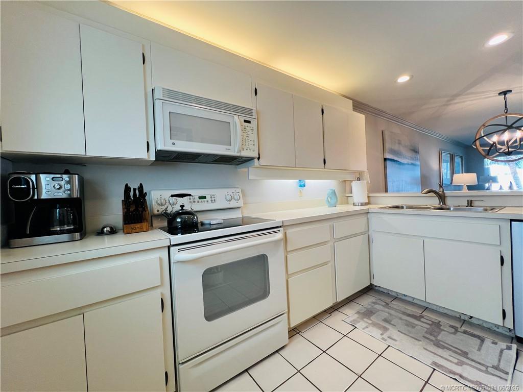 1550 Northeast Ocean Boulevard, Unit C204 Stuart, FL 34996 - Photo 6 of 54 a kitchen with cabinets appliances and a sink