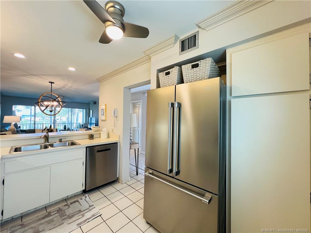 1550 Northeast Ocean Boulevard, Unit C204 Stuart, FL 34996 - Photo 7 of 54 a kitchen with stainless steel appliances a refrigerator and a sink