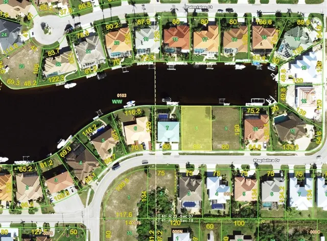 an aerial view of a swimming pool with outdoor seating