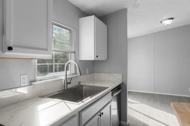 a kitchen with a sink and a window