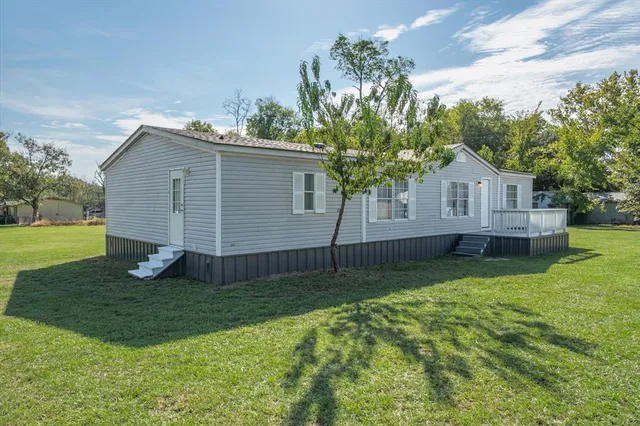 a house that has a tree in front of it