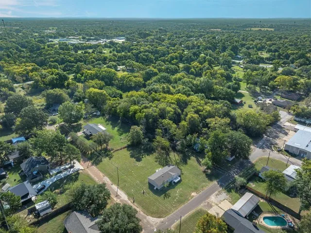 an aerial view of a house with outdoor space