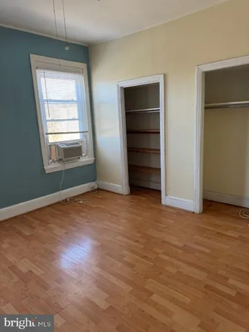 an empty room with windows and closet