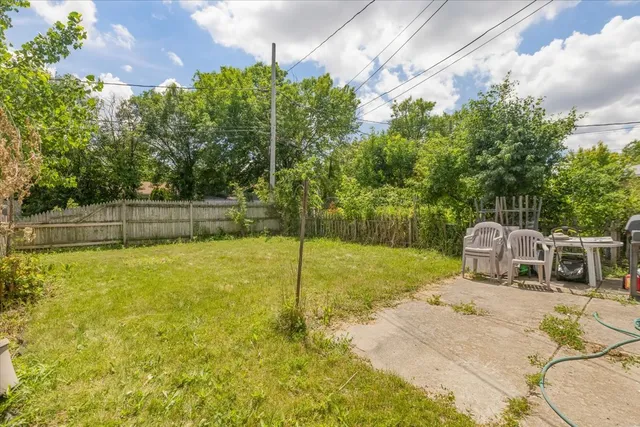 a car parked in front of house with a yard