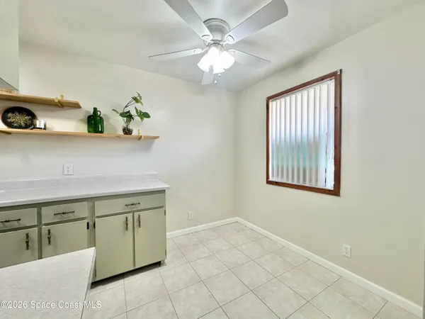 a view of a kitchen with a sink and chandelier