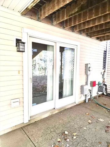 a view of a porch with table and chairs