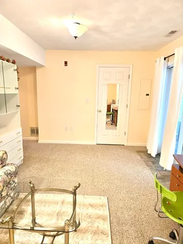 a view of a bedroom with wooden floor and windows