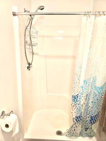 a bathroom with a shower and a shower curtain