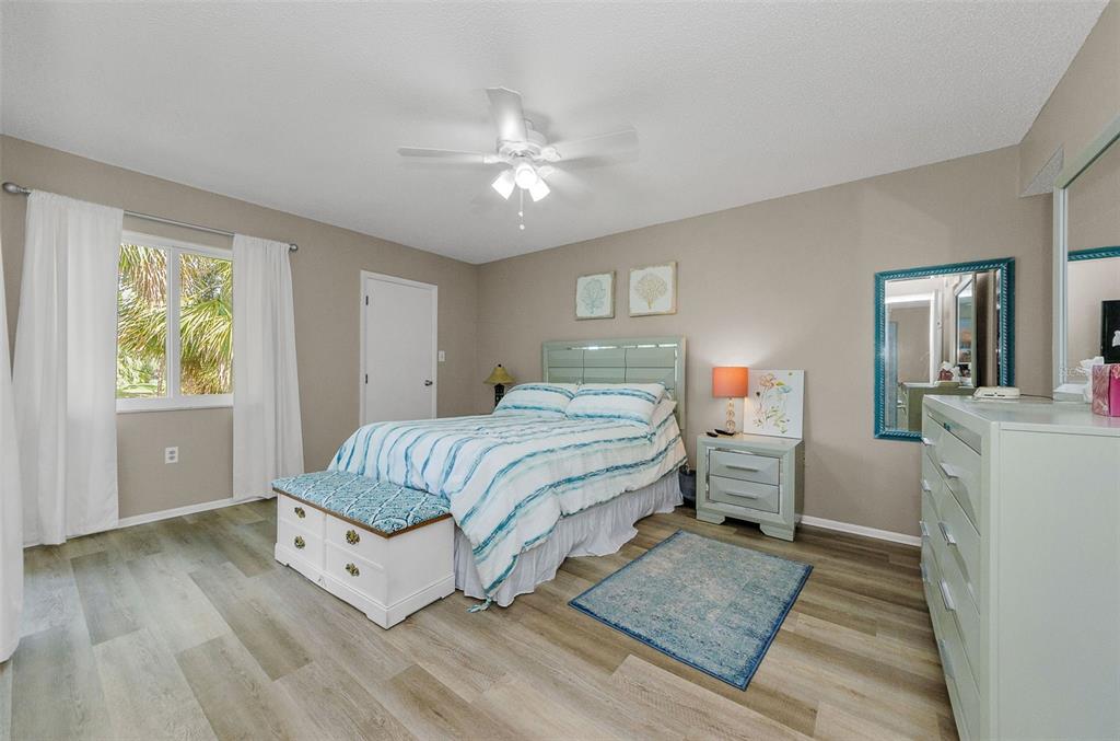 146 Cypress Lane Oldsmar, FL 34677 - Photo 18 of 44 a bedroom with a bed and wooden floor