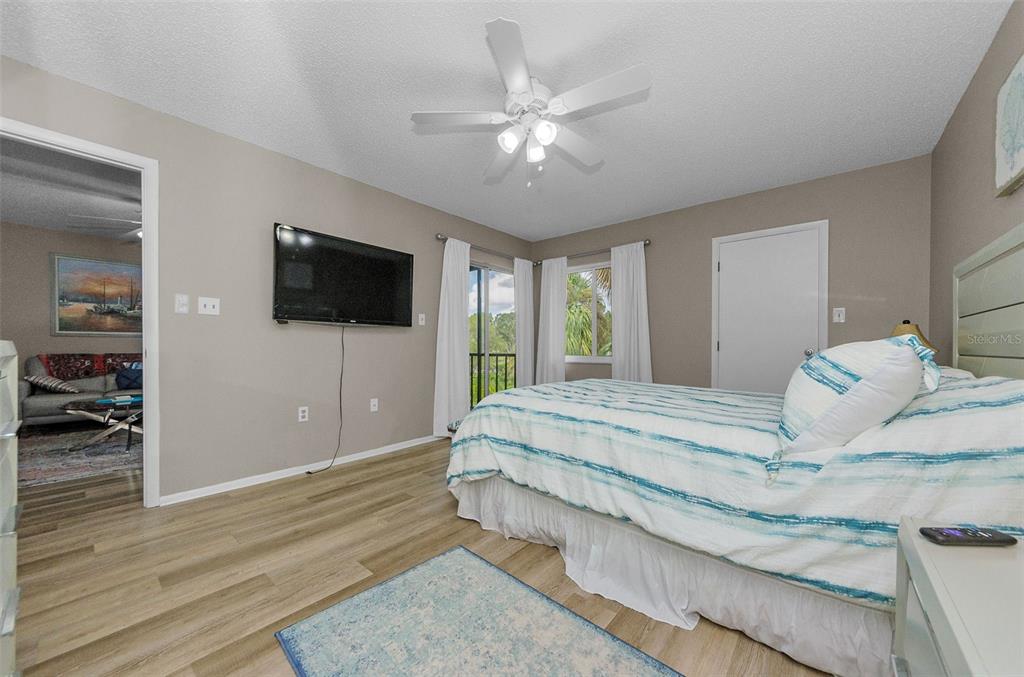 146 Cypress Lane Oldsmar, FL 34677 - Photo 19 of 44 a spacious bedroom with a bed and a flat screen tv