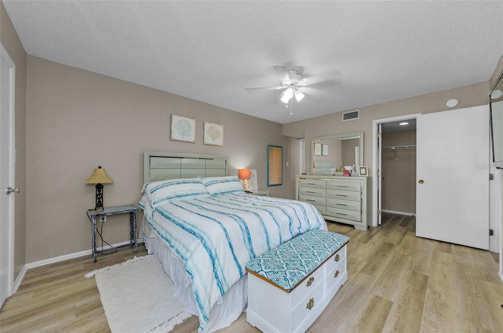 146 Cypress Lane Oldsmar, FL 34677 - Photo 20 of 44 a bedroom with a bed and a chandelier