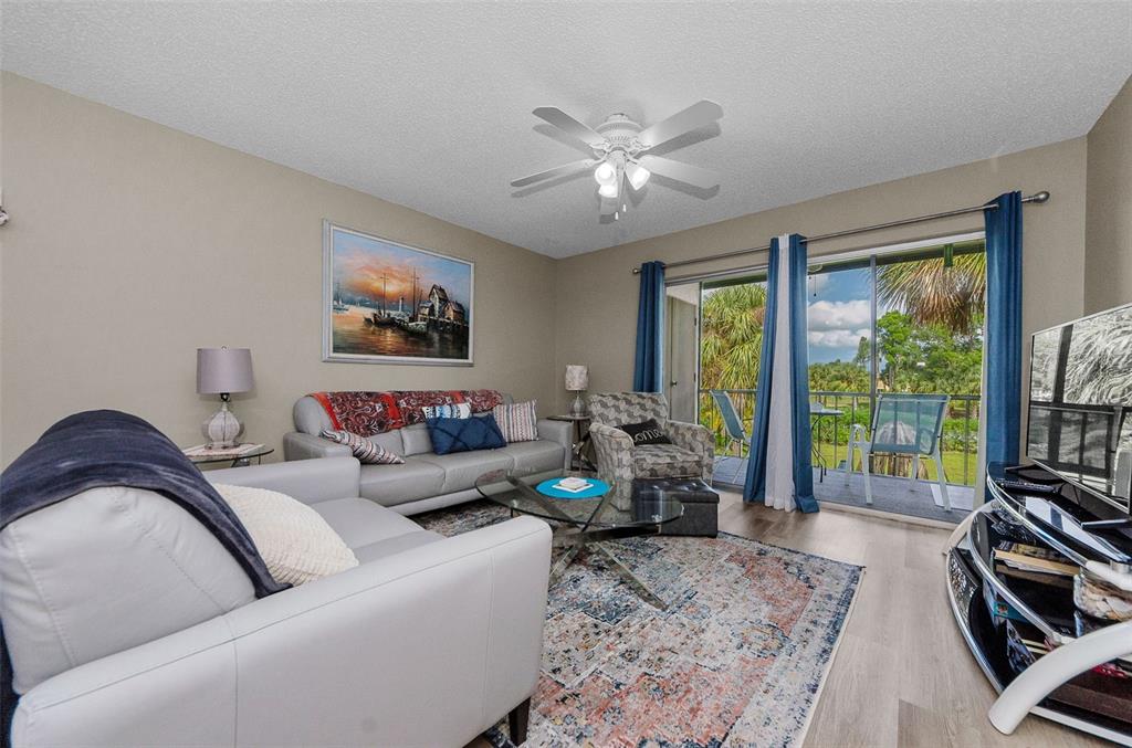 146 Cypress Lane Oldsmar, FL 34677 - Photo 2 of 44 a living room with furniture two window and a flat screen tv