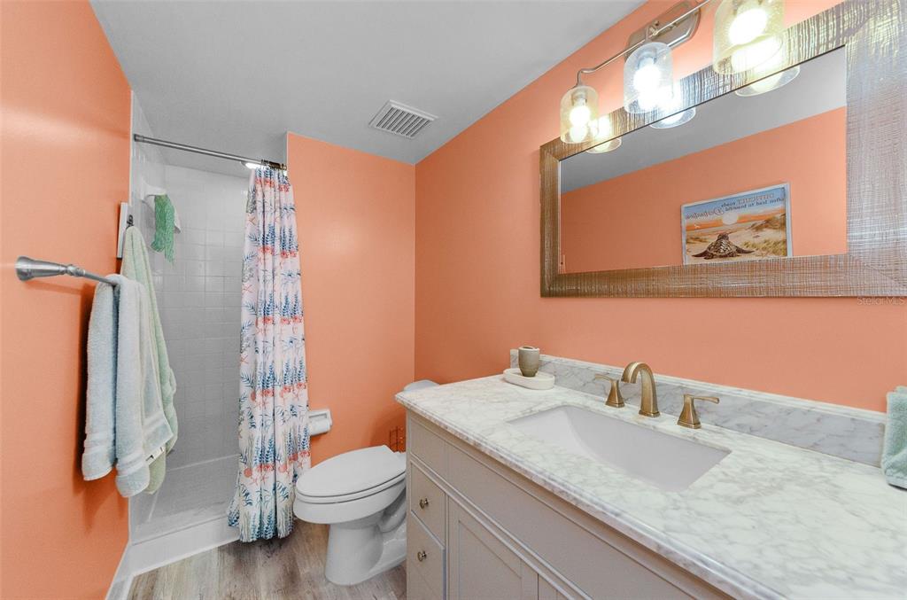 146 Cypress Lane Oldsmar, FL 34677 - Photo 21 of 44 a bathroom with a granite countertop sink toilet and shower