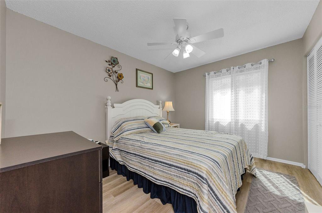 146 Cypress Lane Oldsmar, FL 34677 - Photo 23 of 44 a bedroom with a bed and a chandelier