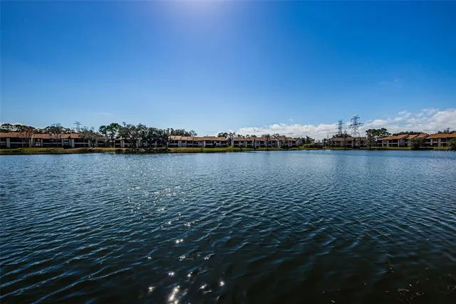 a view of a lake with houses in back