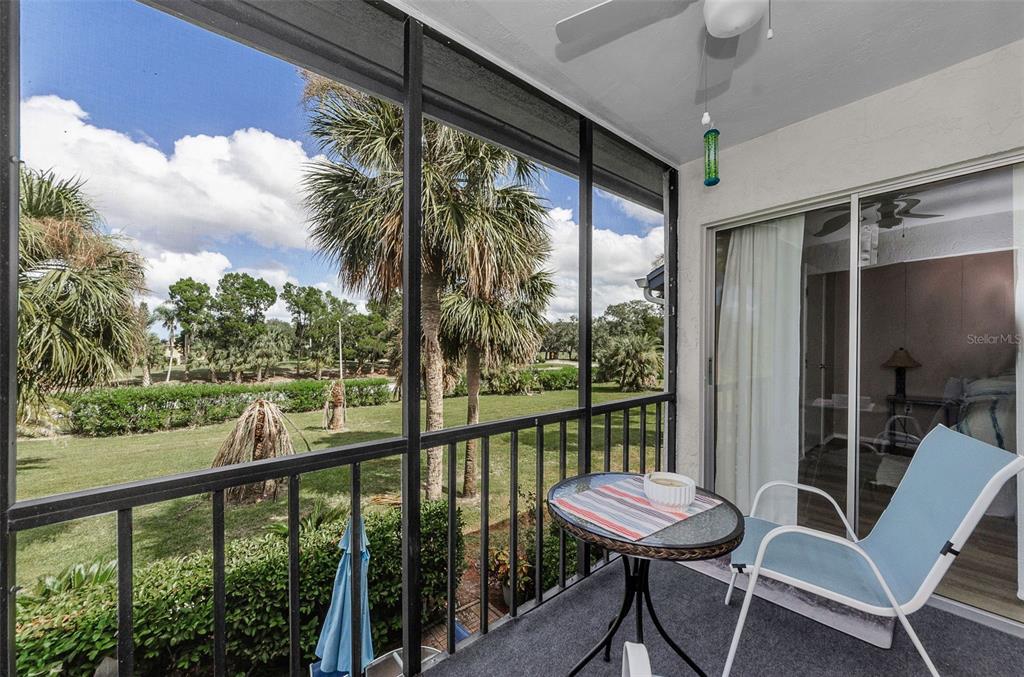 146 Cypress Lane Oldsmar, FL 34677 - Photo 4 of 44 a view of a balcony with furniture and wooden floor