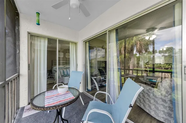 a living room with furniture and a floor to ceiling window