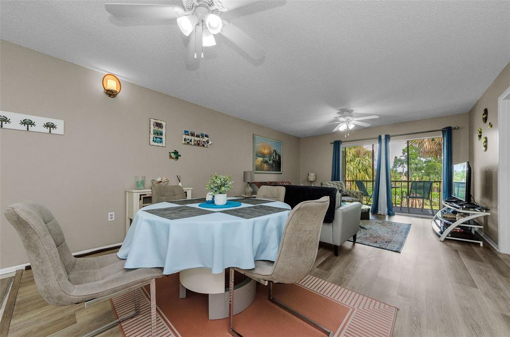 146 Cypress Lane Oldsmar, FL 34677 - Photo 9 of 44 a room with furniture a ceiling fan a rug and a large window