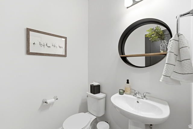 6039 North Westridge Road Heber City, UT 84032 - Photo 21 of 71 Pedestal sink with chrome faucet, wall-mounted circular mirror with integrated wood-finish shelf, and polished chrome towel bar
