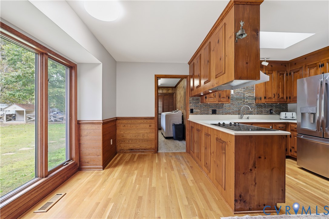 8100 Gold Acres Farm Road Prince George, VA 23875 - Photo 17 of 50 Kitchen with wainscoting, brown cabinets, stainles