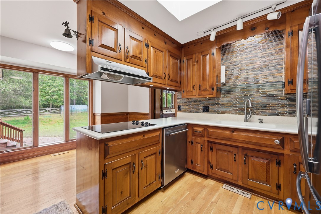 8100 Gold Acres Farm Road Prince George, VA 23875 - Photo 18 of 50 Kitchen with brown cabinets, light countertops, ta