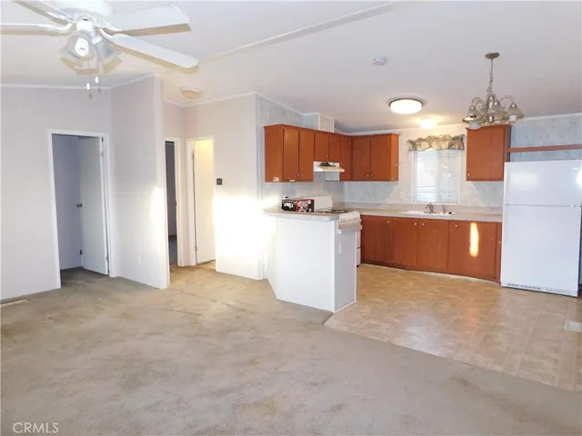 a view of a kitchen with a sink and chandelier
