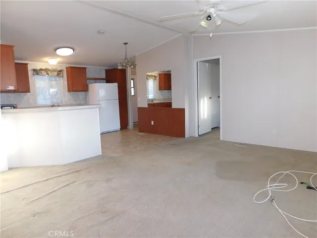 an empty room with a cabinet and mirror
