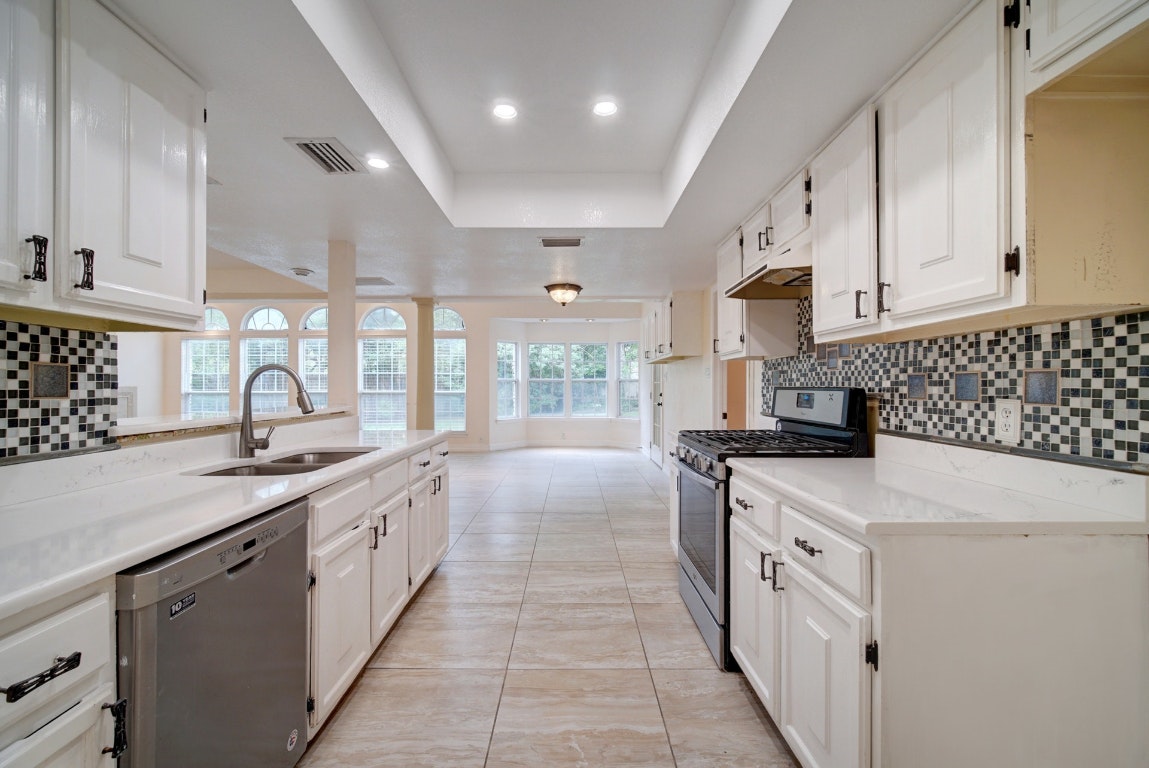 10509 Doering Lane Austin, TX 78750 - Photo 1 of 36 a kitchen with granite countertop a sink and a stove