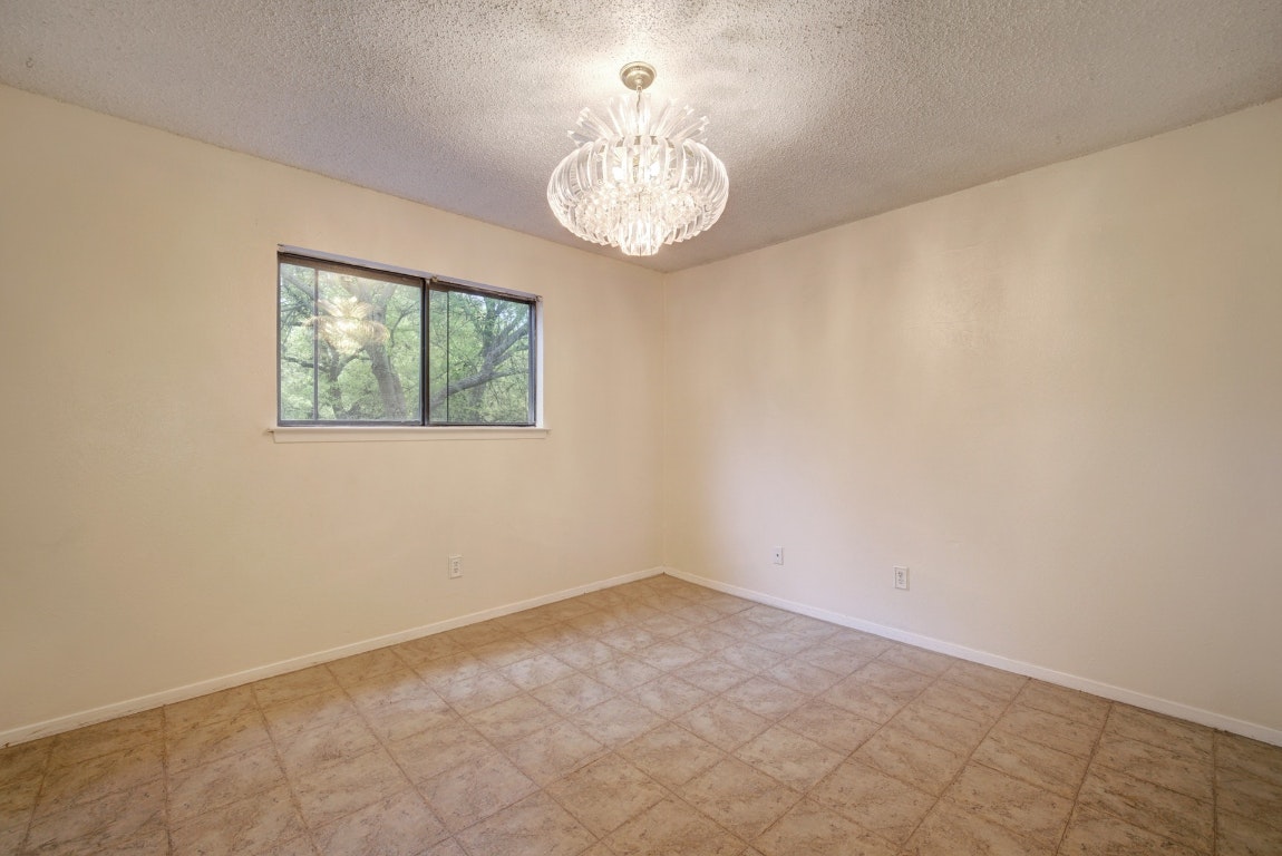 10509 Doering Lane Austin, TX 78750 - Photo 12 of 36 an empty room with windows and chandelier fan