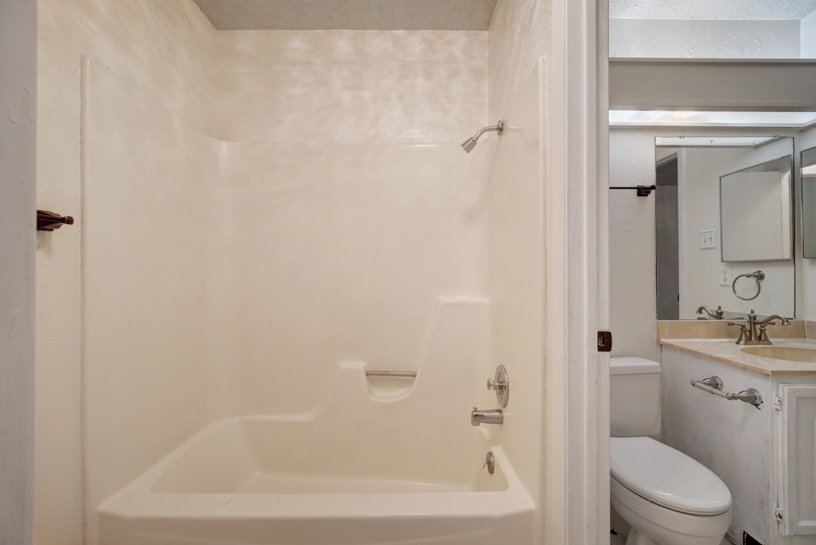 10509 Doering Lane Austin, TX 78750 - Photo 16 of 36 a bath room with a toilet sink and shower