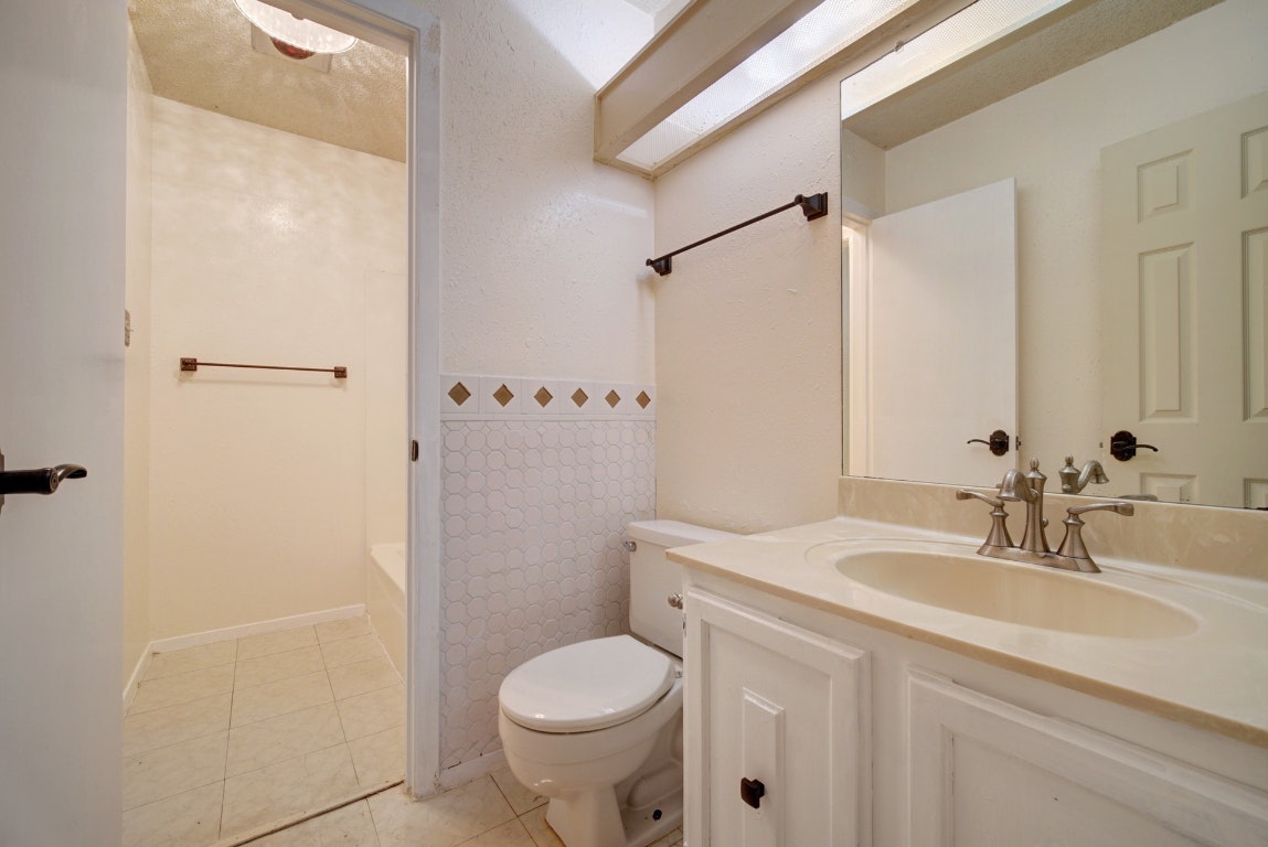 10509 Doering Lane Austin, TX 78750 - Photo 17 of 36 a bathroom with a sink toilet and shower
