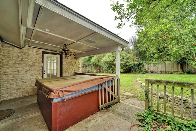 a view of a backyard with table and chairs under an umbrella