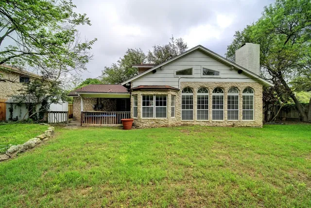 a front view of house with yard barbeque and outdoor seating