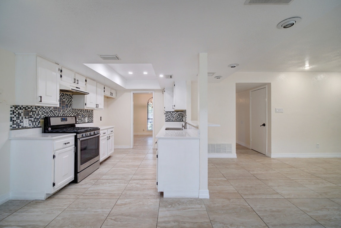 10509 Doering Lane Austin, TX 78750 - Photo 31 of 36 a large kitchen with cabinets and stainless steel appliances